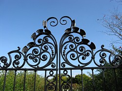 Traditional overthrow to rose garden gate on estate in Hampshire